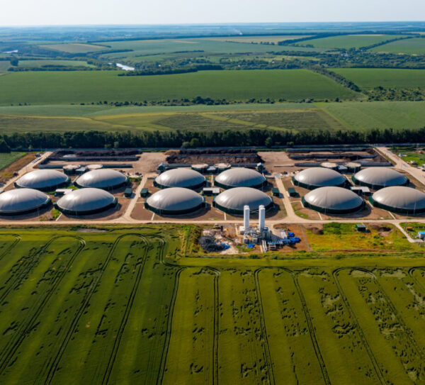 Production of sustainable fuel called bio gas. New factory in field. View from above. Ecological production concept